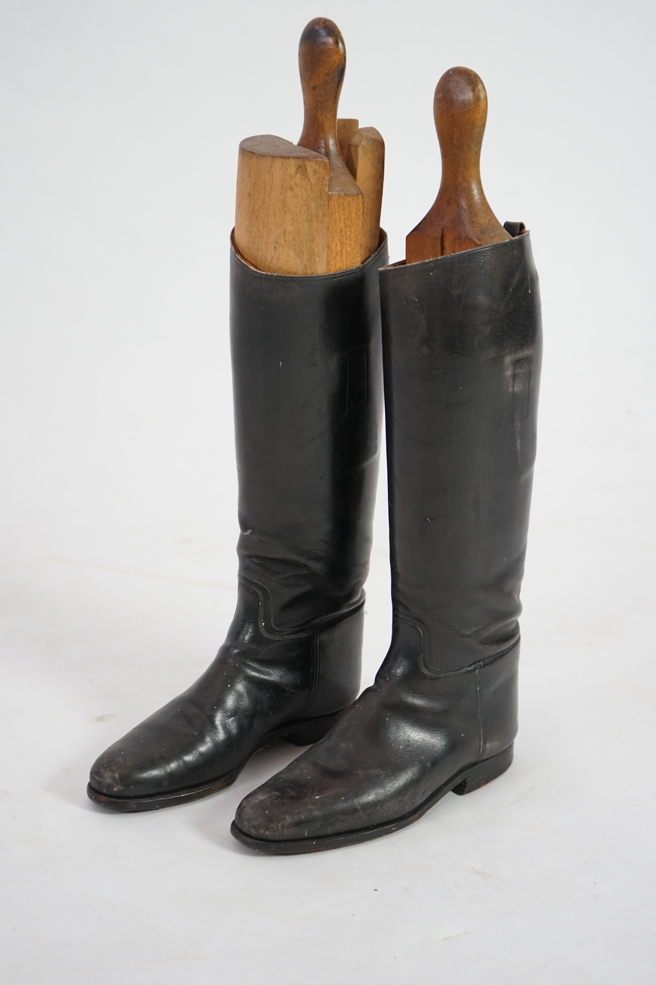 A pair of black leather riding boots